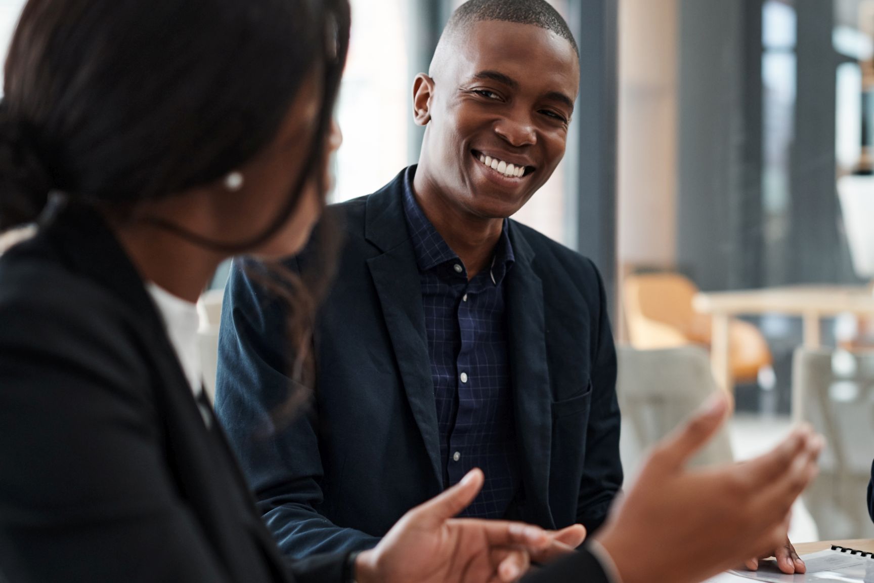 Everybody loves a colleague who understands them. a young businessman and businesswoman having a meeting in a modern office.
